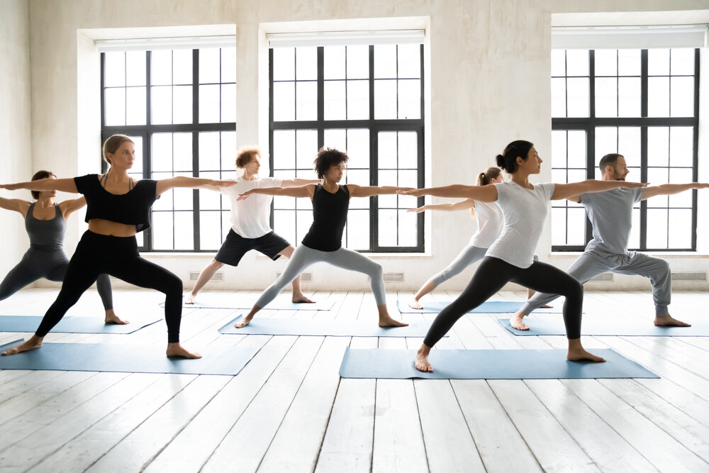 People practicing yoga in a home setting